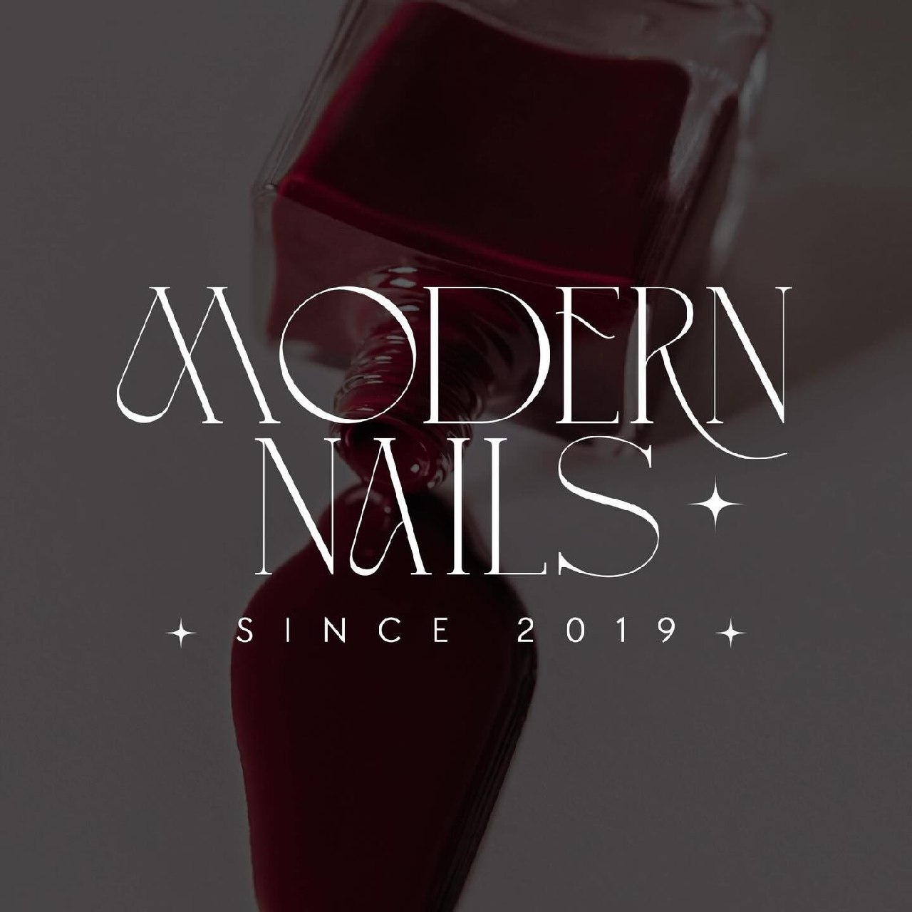 Modern Nails brand detail with a deep burgundy nail-care bottle
